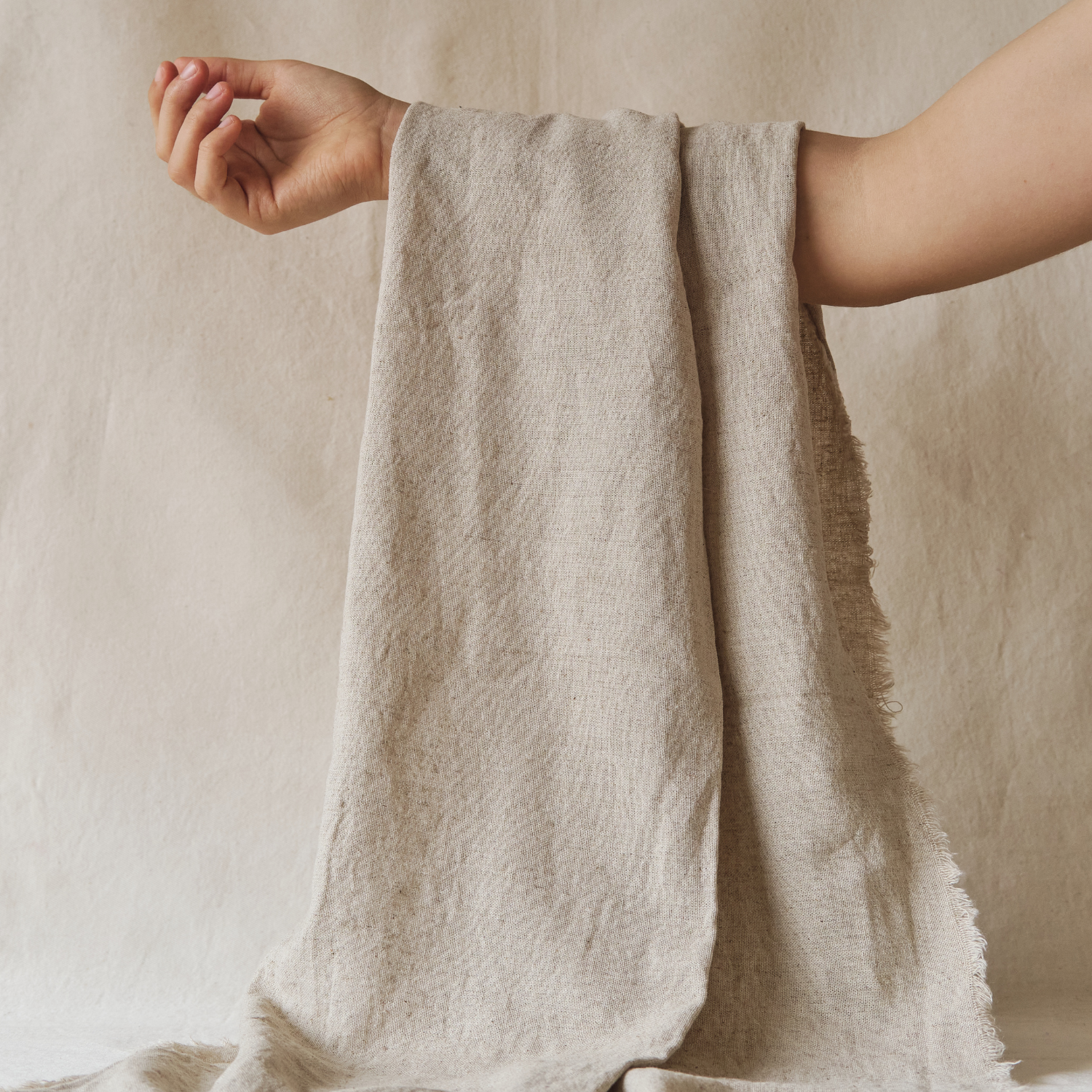 Trimita natural linen fabric held by hand – breathable, biodegradable, sustainable textile