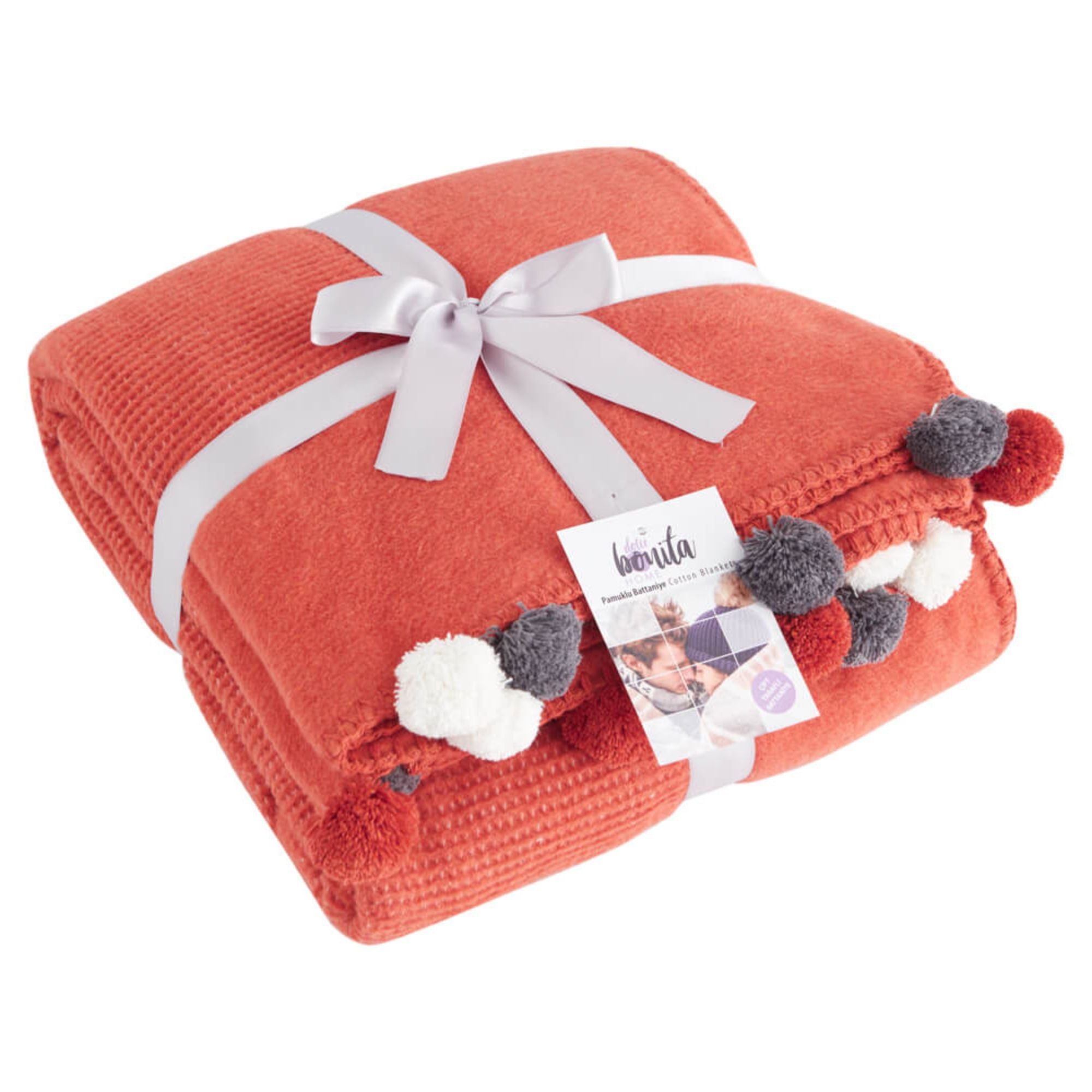 Folded tile red pompom blanket with gift ribbon, perfect holiday present, high-quality cotton blend textile Trimita.