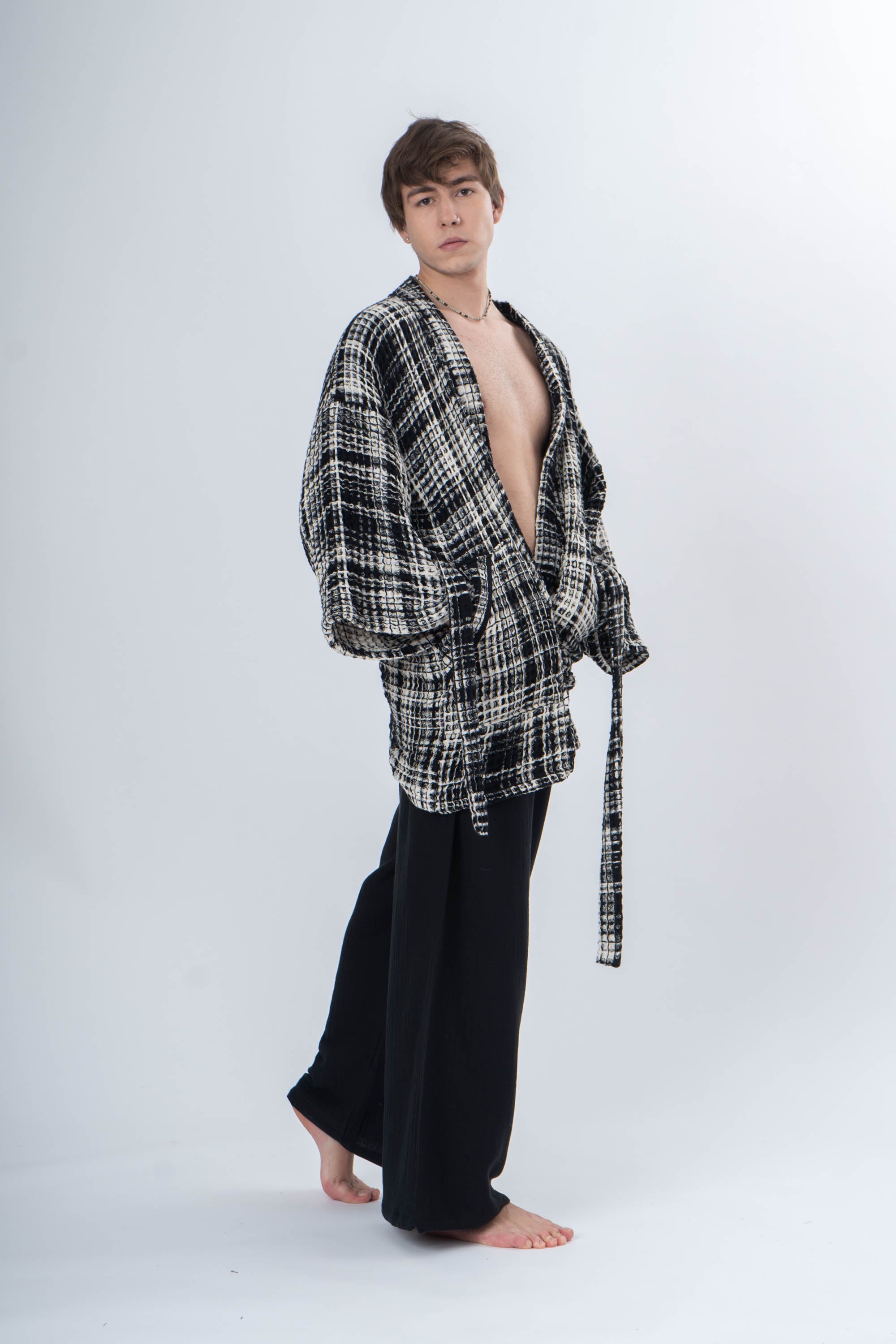 A boy wearing a Trimita Prana Klimono and black pants on a white background