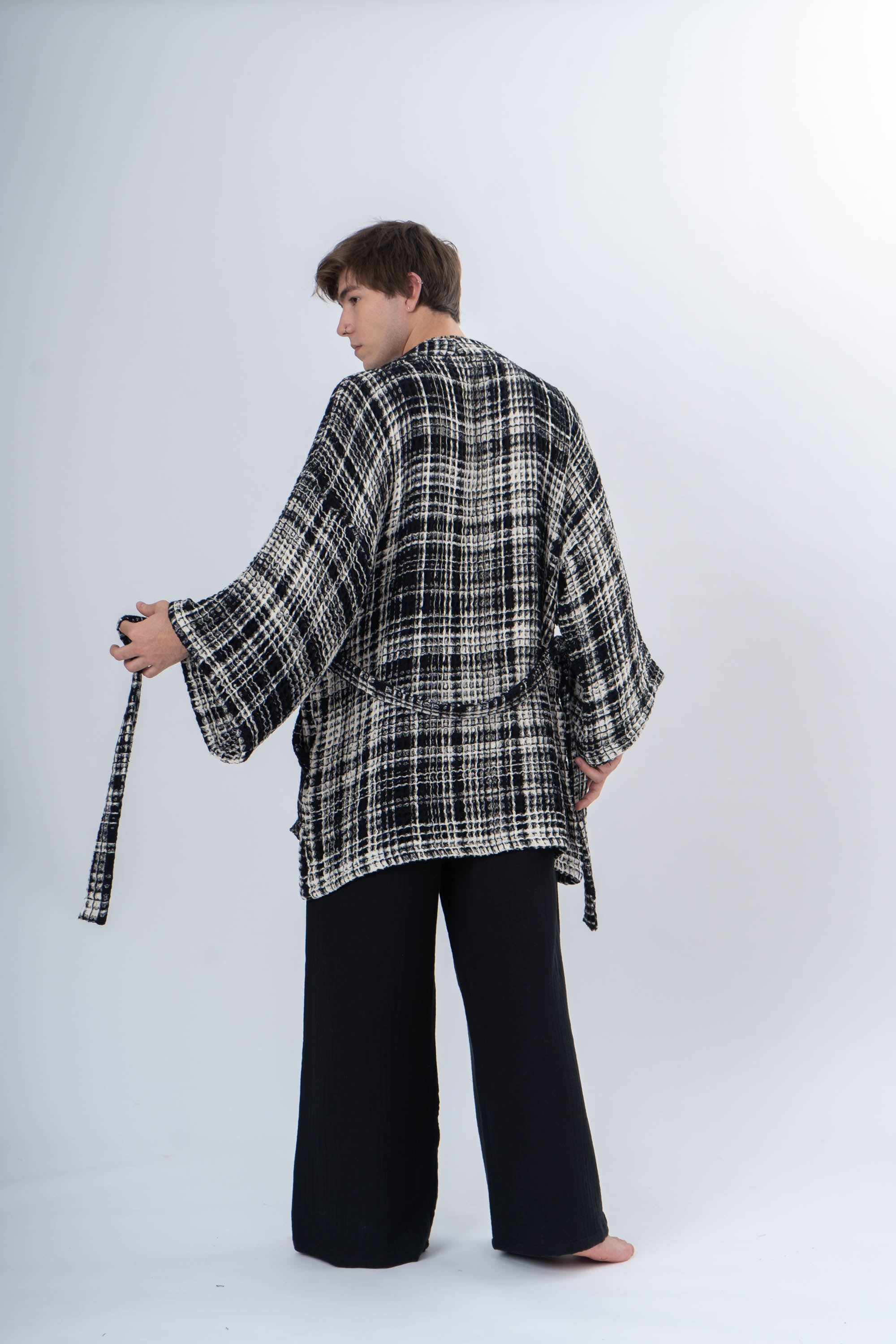 Man wearing a black Trimita Prana Kimono and black pants on a white background.