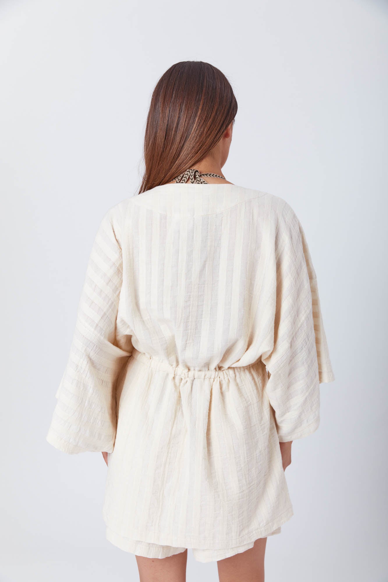 Stylish woman in earthy-toned loungewear, embodying effortless comfort and modern boho vibes