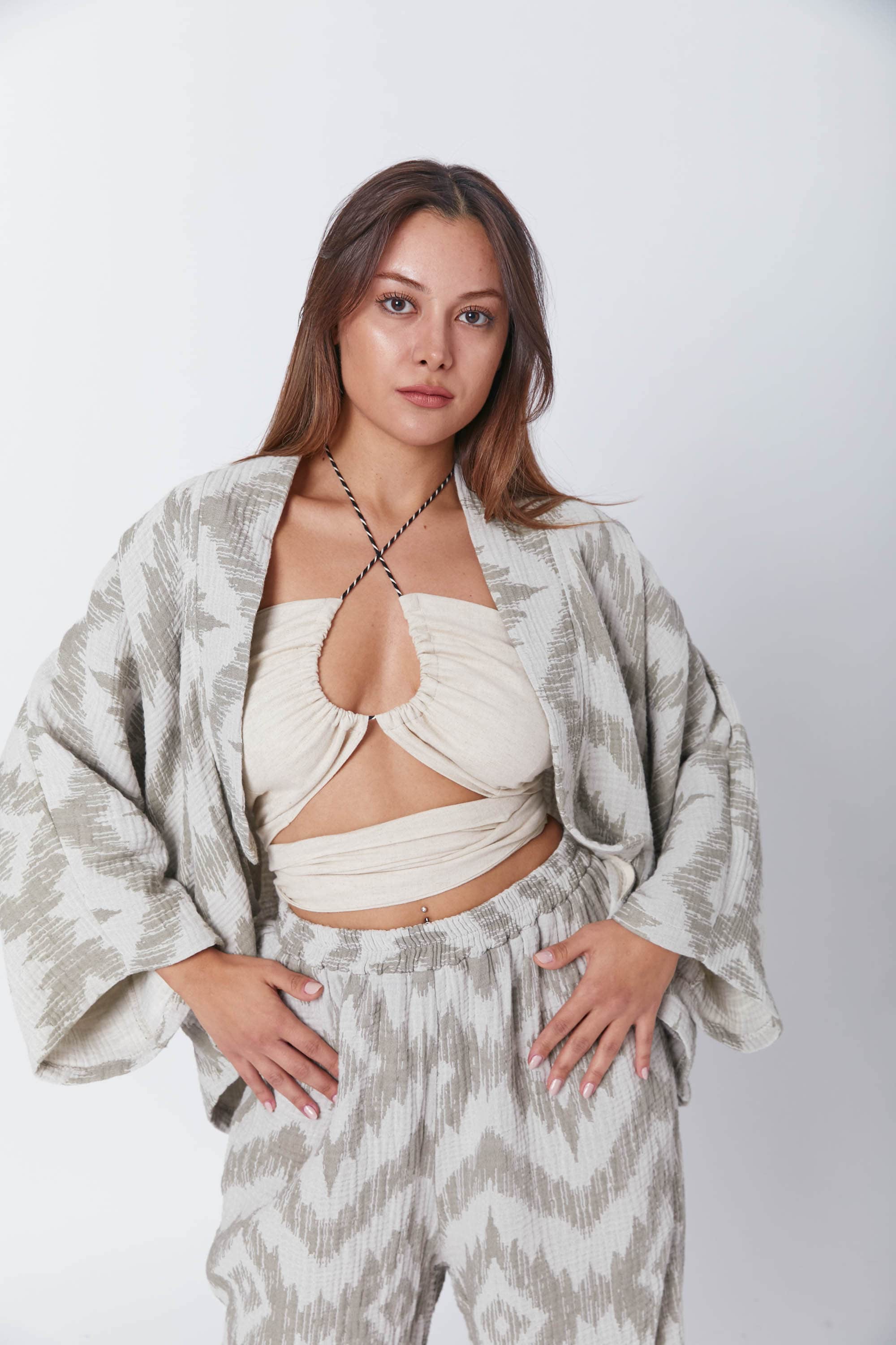 Guru Green muslin jacket with a light ikat print, oversized sleeves, and an effortless drape, styled over a minimalist crop top.