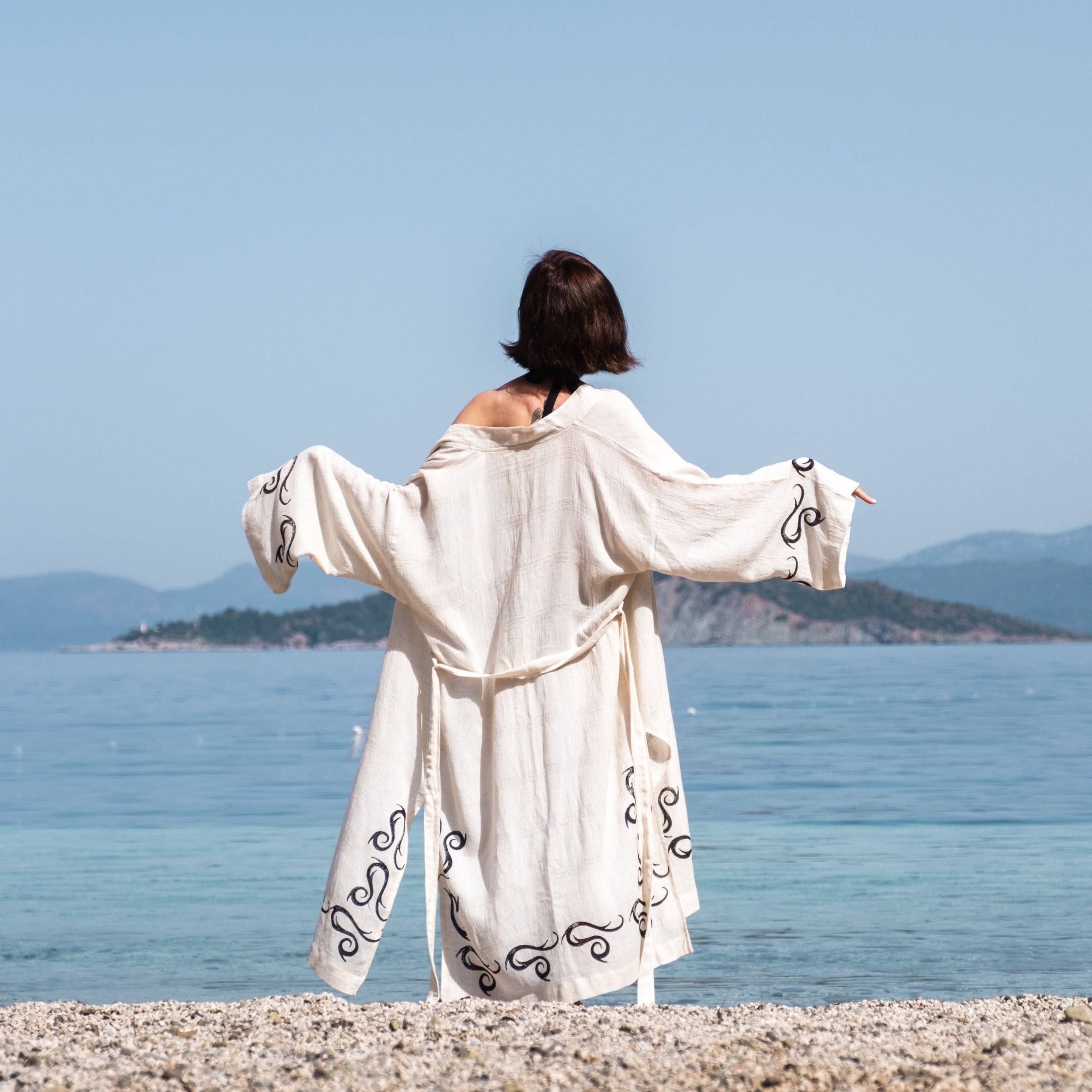 Handcrafted kimono made from a 70% linen, 30% cotton blend, dyed with natural root dyes and printed with linden tree blocks. The garment is one-size-fits-all, fitting sizes small through large.