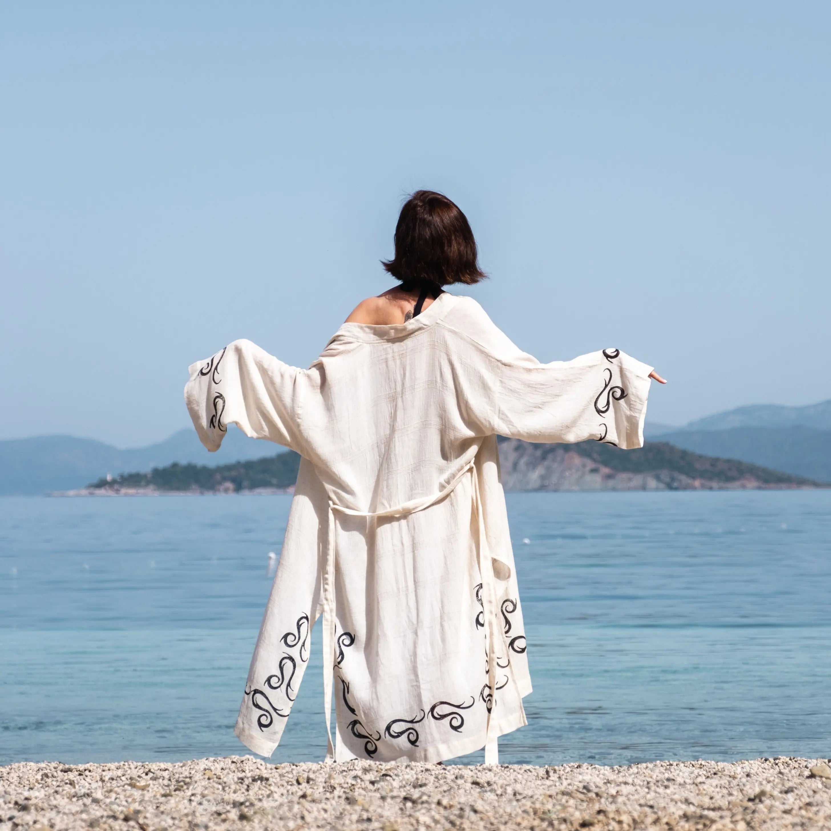 Handcrafted kimono made from a 70% linen, 30% cotton blend, dyed with natural root dyes and printed with linden tree blocks. The garment is one-size-fits-all, fitting sizes small through large.