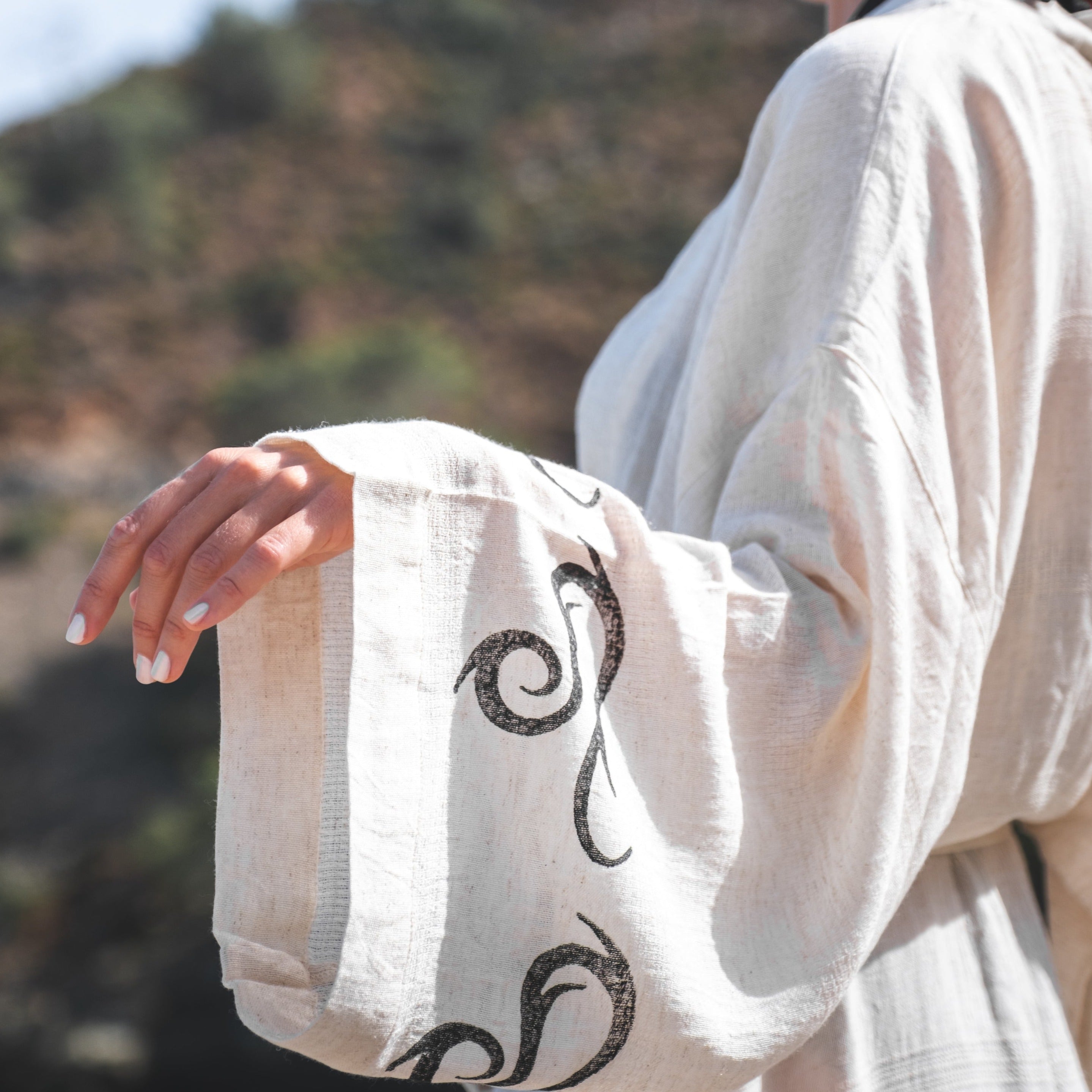 Handcrafted kimono made from a 70% linen, 30% cotton blend, dyed with natural root dyes and printed with linden tree blocks. The garment is one-size-fits-all, fitting sizes small through large.