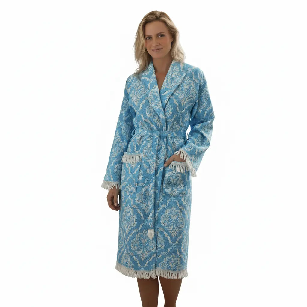 Woman wearing a Trimita Bathrobe blue with white trim on a white background