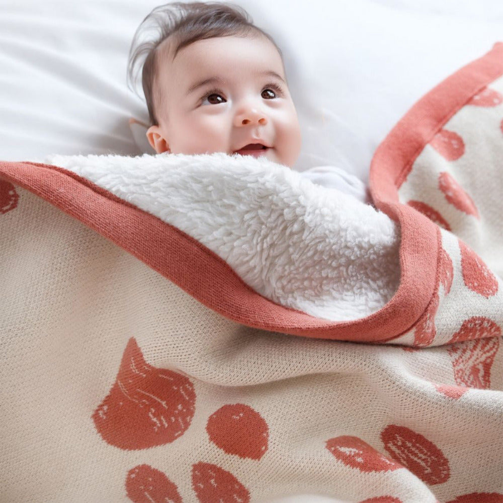 A little one wrapped in a soft amberglow organic cotton baby swaddle. Eco-friendly and ideal for sensitive skin.