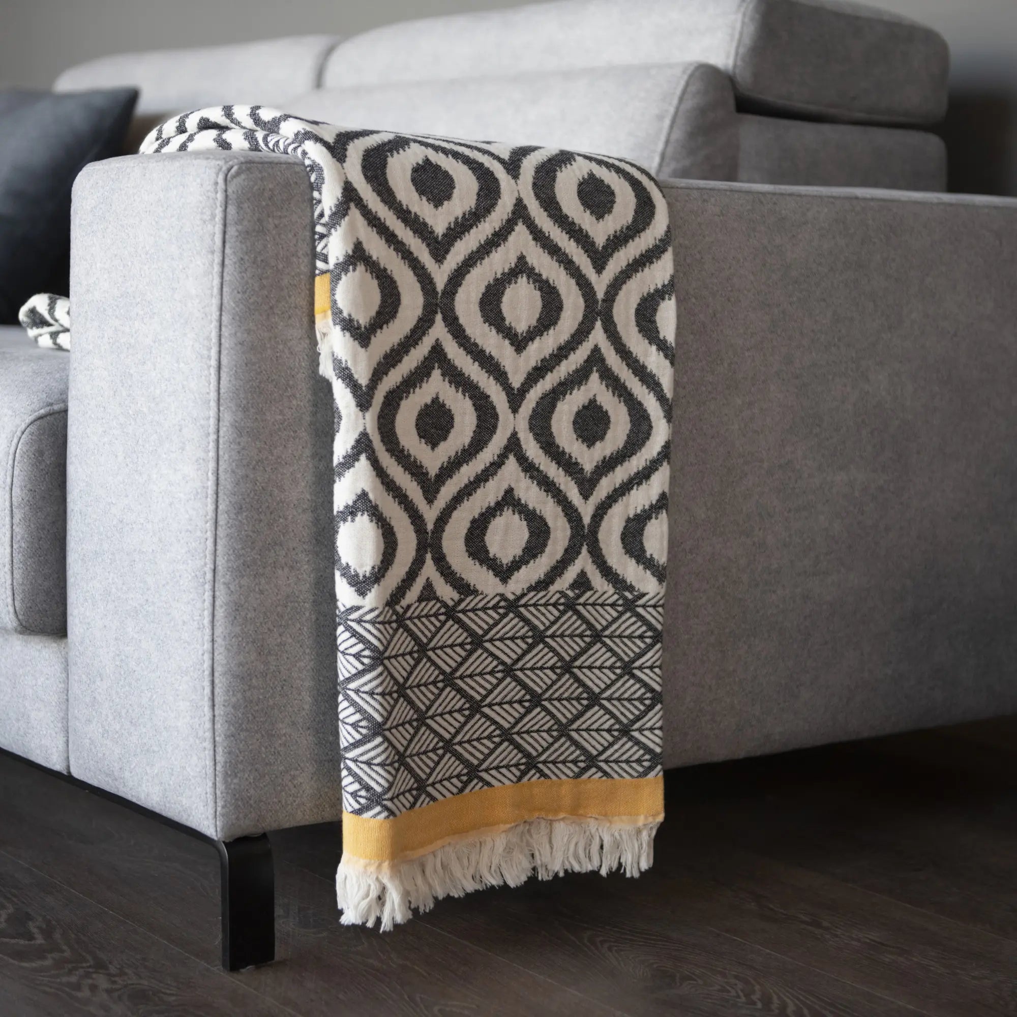 Black and yellow striped Asude Turkish cotton throw blanket with authentic ikat and chevron weave, fair trade certified, perfect as a lightweight bed cover or stylish living room accessory.