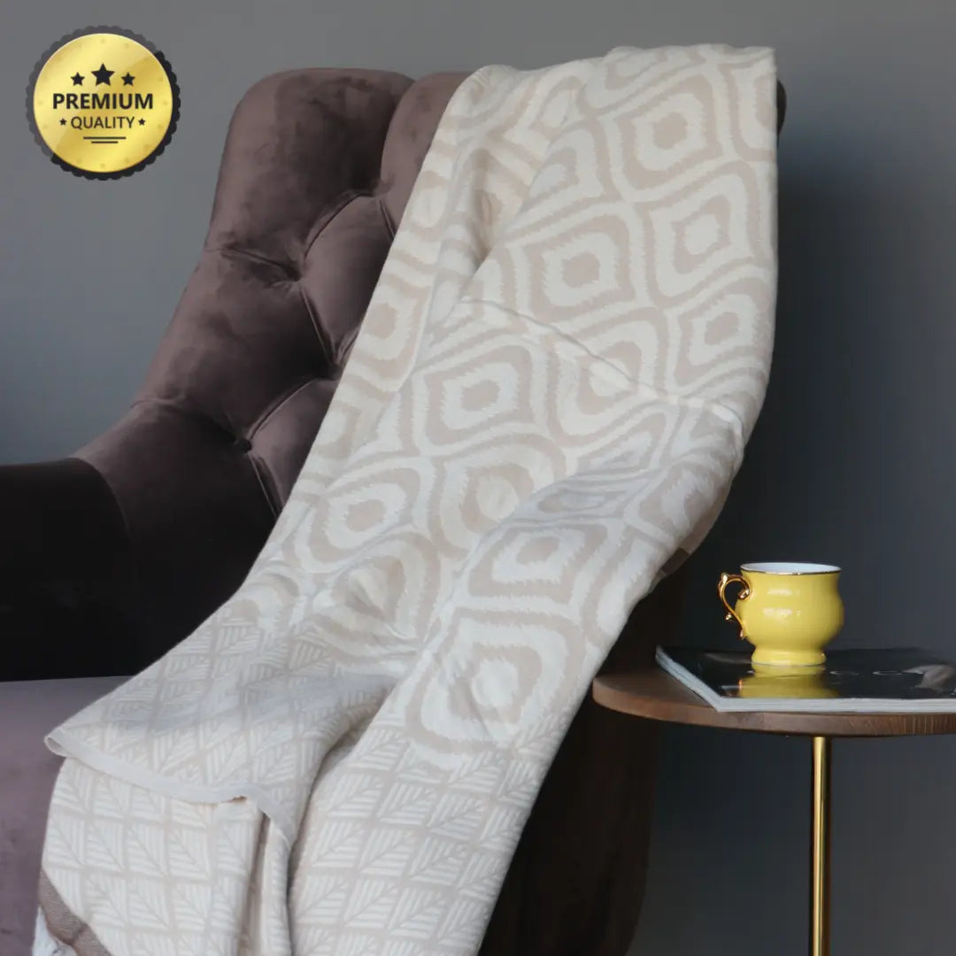 Boho-style beige and coffee brown diamond pattern cotton throw blanket styled on a chair, showcasing traditional craftsmanship and natural fibers.