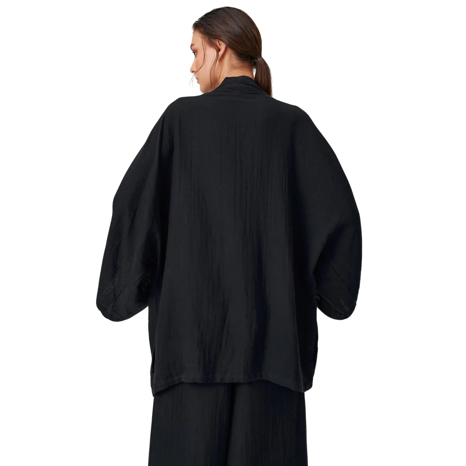 Back view of a minimalist black cotton muslin kimono robe with a defined waist belt and a clean silhouette.