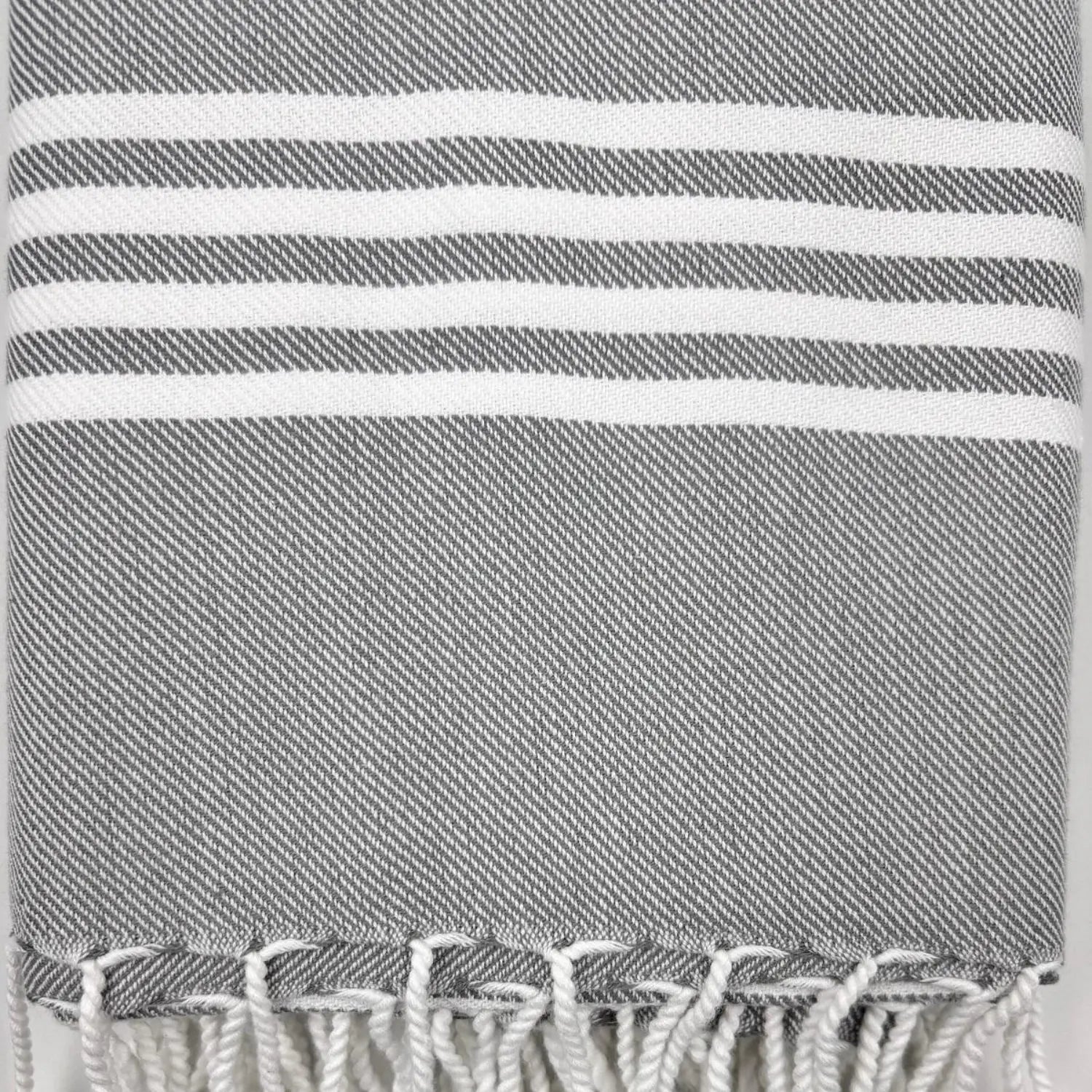 Close-up of the charcoal grey cotton fibers and striped pattern of a Turkish pestemal.