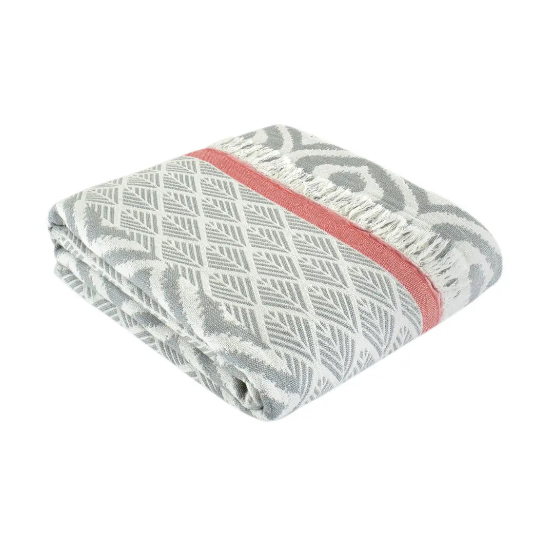 Folded grey and red accent Turkish cotton throw blanket showcasing a combination of chevron and diamond weaves, OEKO-TEX certified for sustainable home decor.