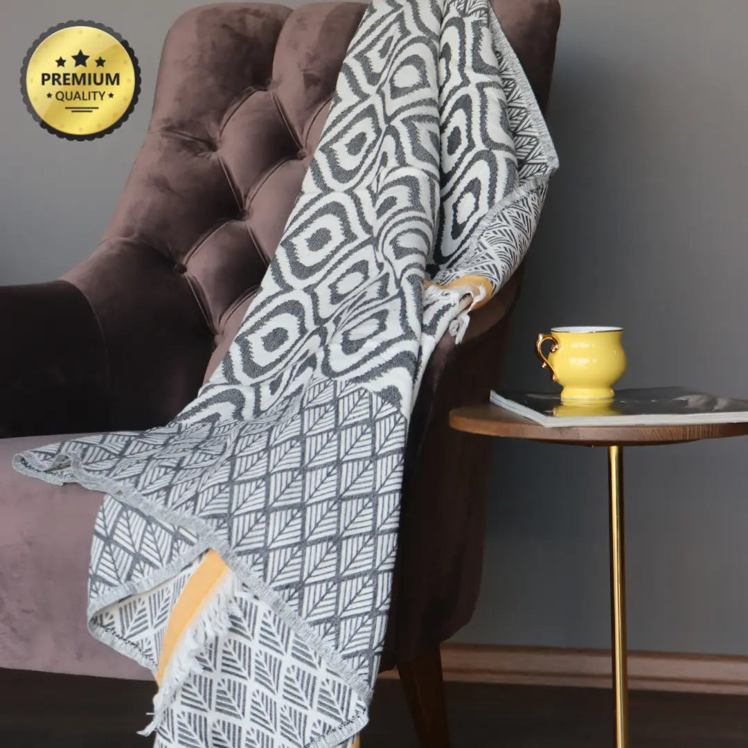 Grey and yellow striped Turkish cotton throw blanket styled in a contemporary interior, eco-friendly and stylish textile for sofas and beds.