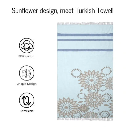 An informational image featuring a light blue Turkish cotton towel with a brown sunflower pattern and blue stripes, alongside icons detailing benefits: 100% cotton, unique design, and reversible.