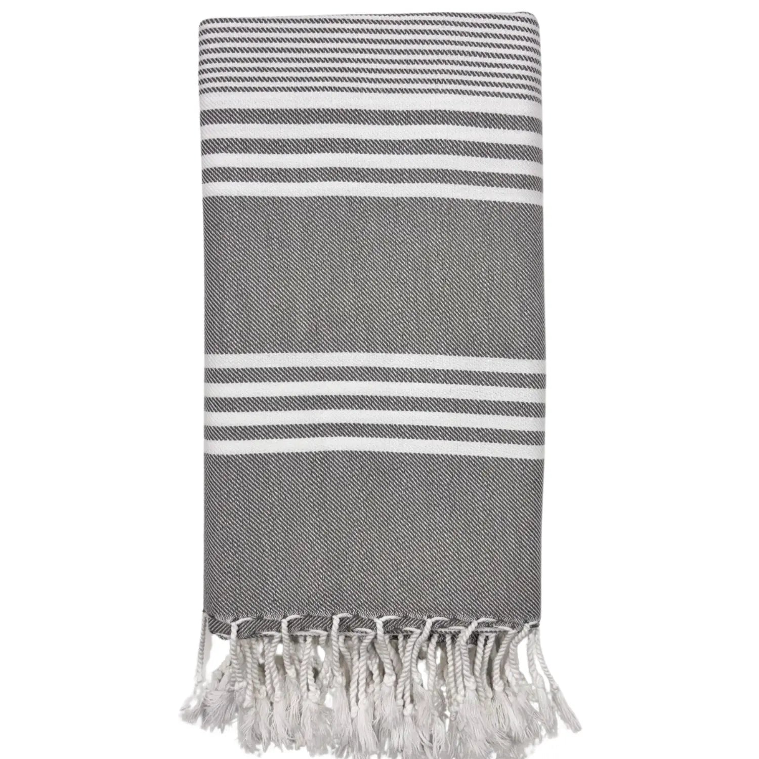 Minimalist black Turkish beach towel with hand-knotted fringes hanging on a decorative ladder.