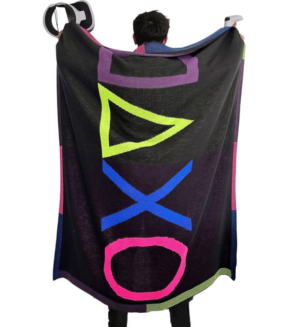 Person wearing a colorful towel with gaming console symbols on a white background