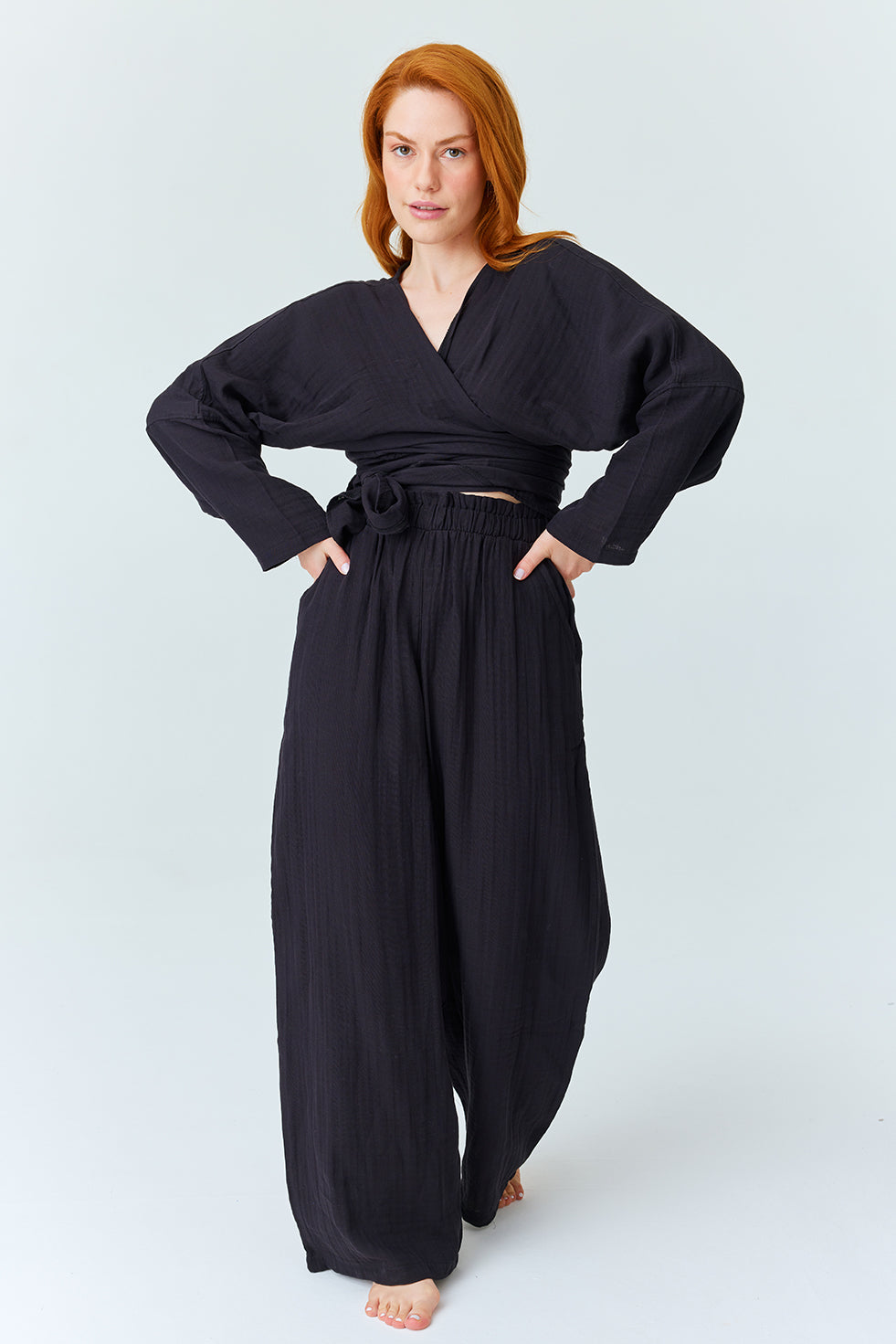 Model in a casual black two-piece loungewear set