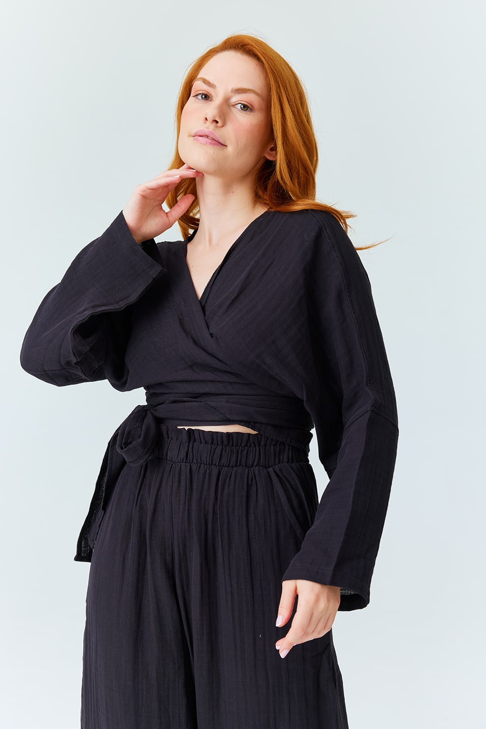Elegant casualwear for women – black wrap top with tie and relaxed pants