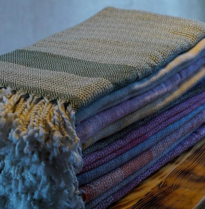 A full-length vertical shot of the black Spring herringbone Turkish peshtemal towel by Trimita.