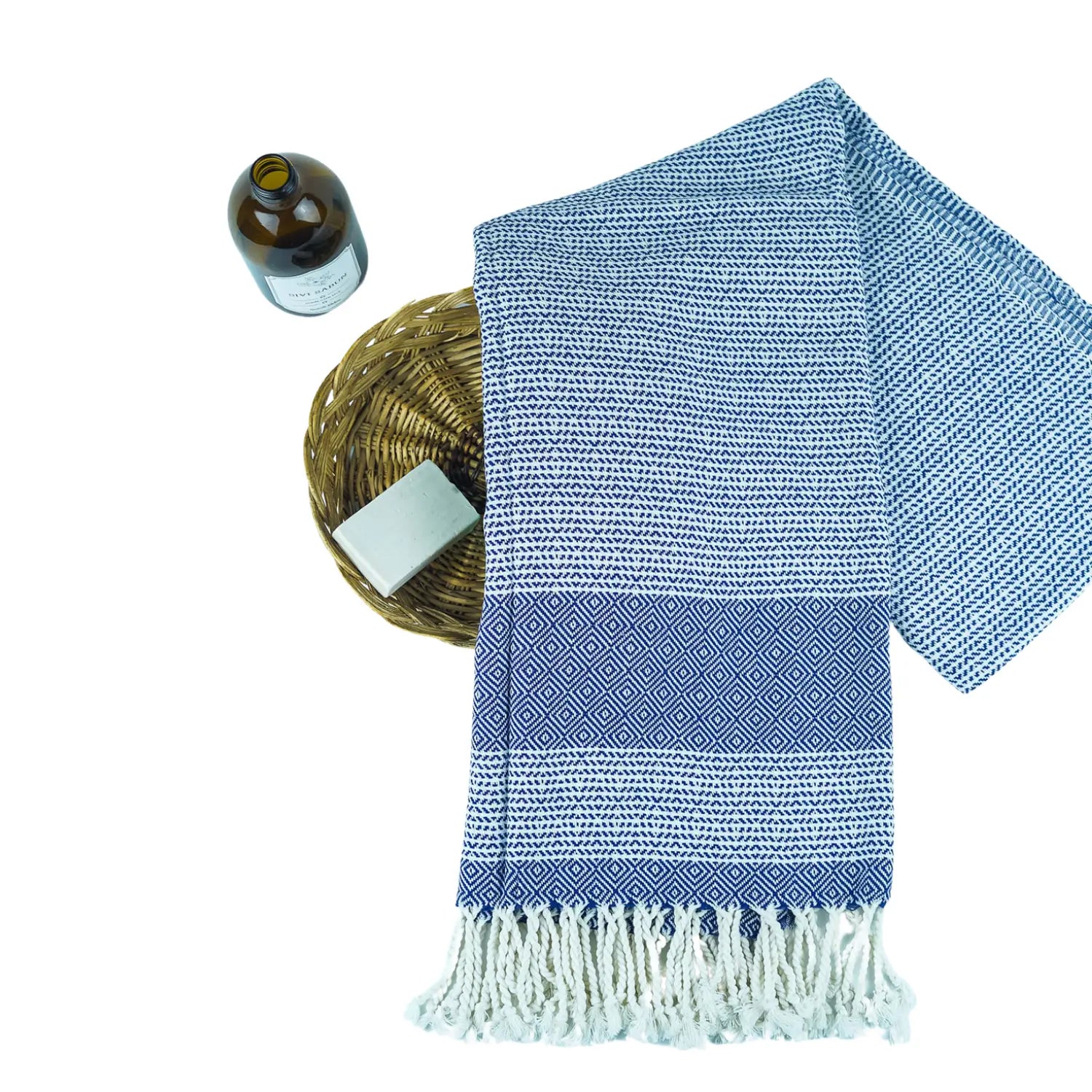 Blue Spring herringbone Turkish peshtemal towel draped elegantly in a bohemian-style living room.