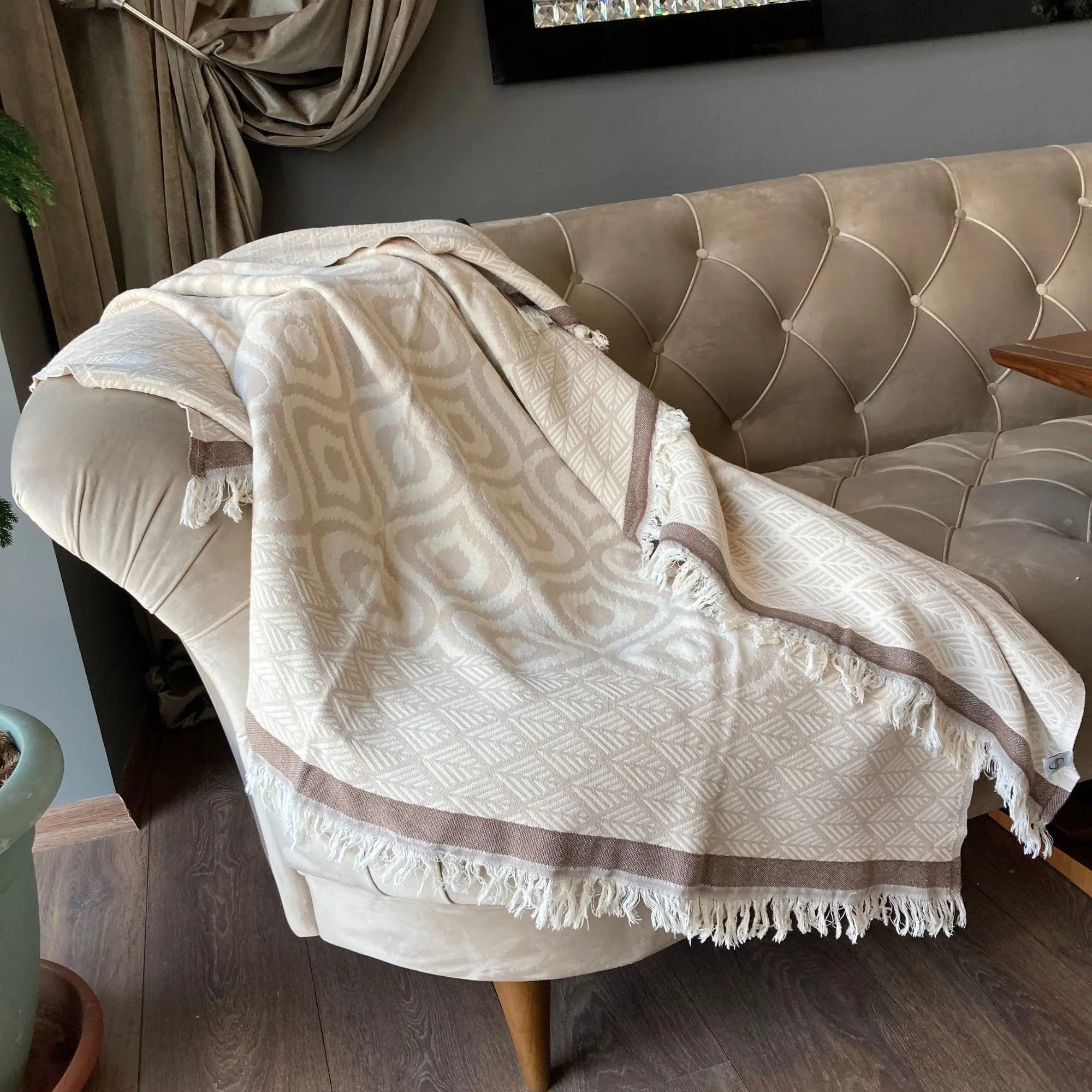 Handwoven Asude 100% Turkish cotton throw blanket in beige and coffee, featuring a boho diamond pattern and fringed edges for a cozy farmhouse interior.