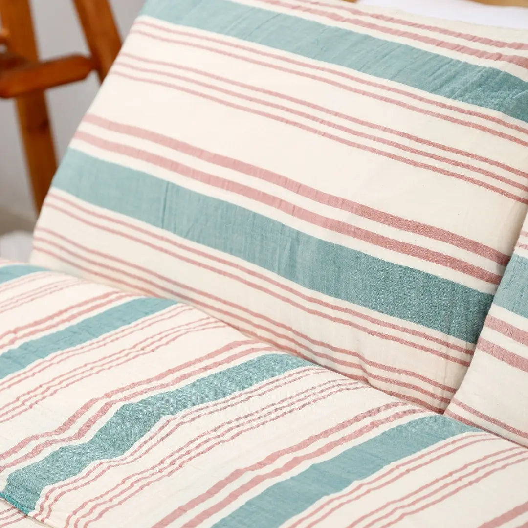 Close-up of striped fabric with pink and blue lines on a white background
