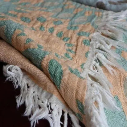 Soft texture and folded view of Trimita sunflower series orange and green cotton Turkish towel.