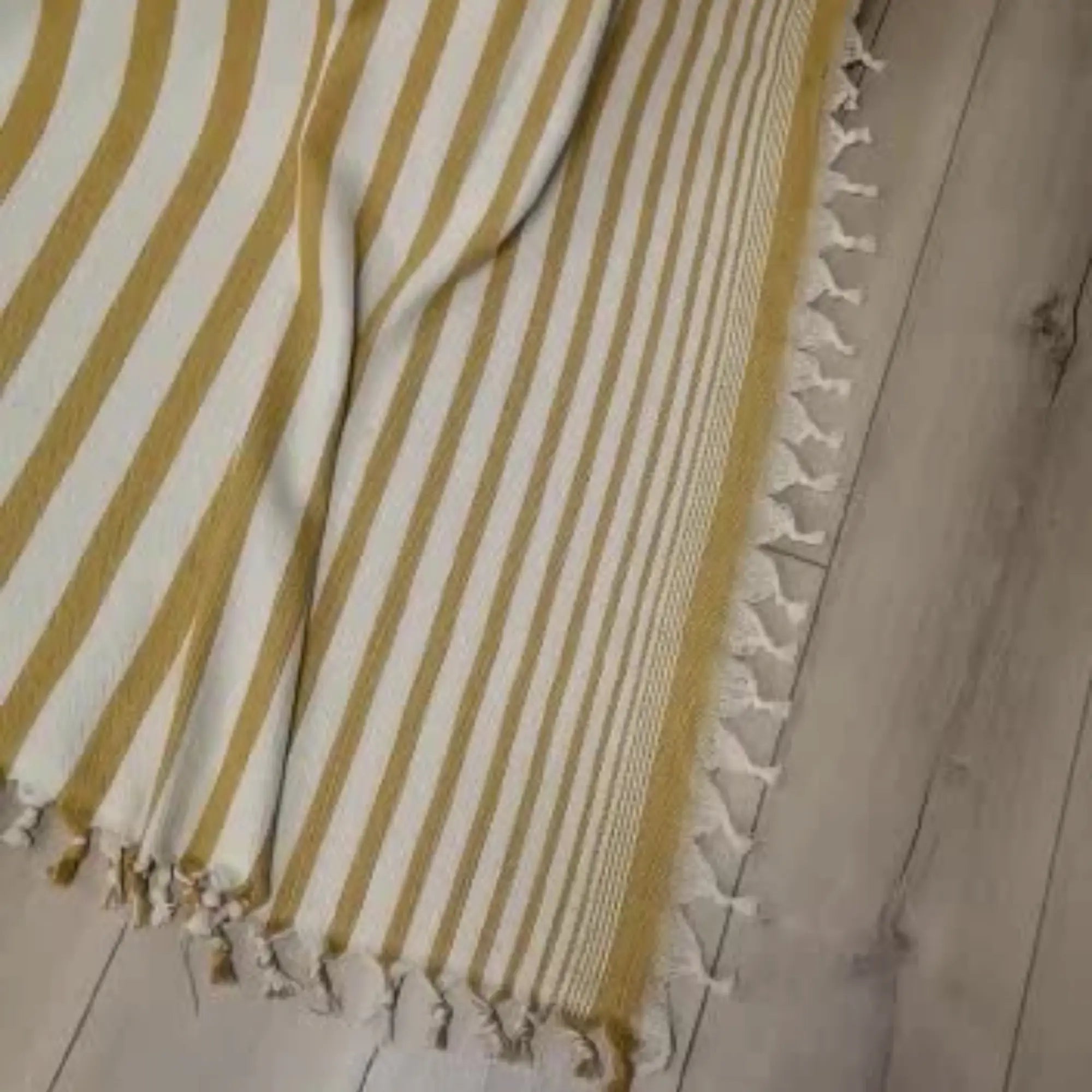 Couvre-lit Trimita Sevda rayé jaune moutarde en coton naturel, posé au sol