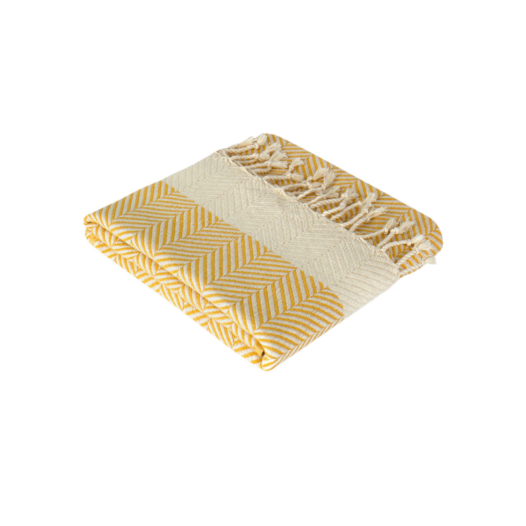 Image of the Hiera Extra Long Turkish Hammam towel. The towel displays a rich color and a distinctive herringbone pattern, hinting at its versatility as a beach or bathroom towel, pool cover, sofa cover, couch throw, and shawl. Its luxurious, quick-drying Turkish Cotton material is subtly showcased.