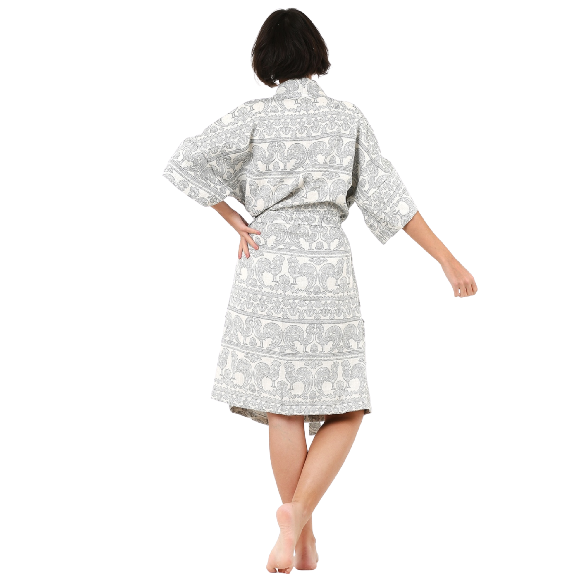 A girl standing with her back turned wearing Trimita Mousseline Kimono Badjas Rooster