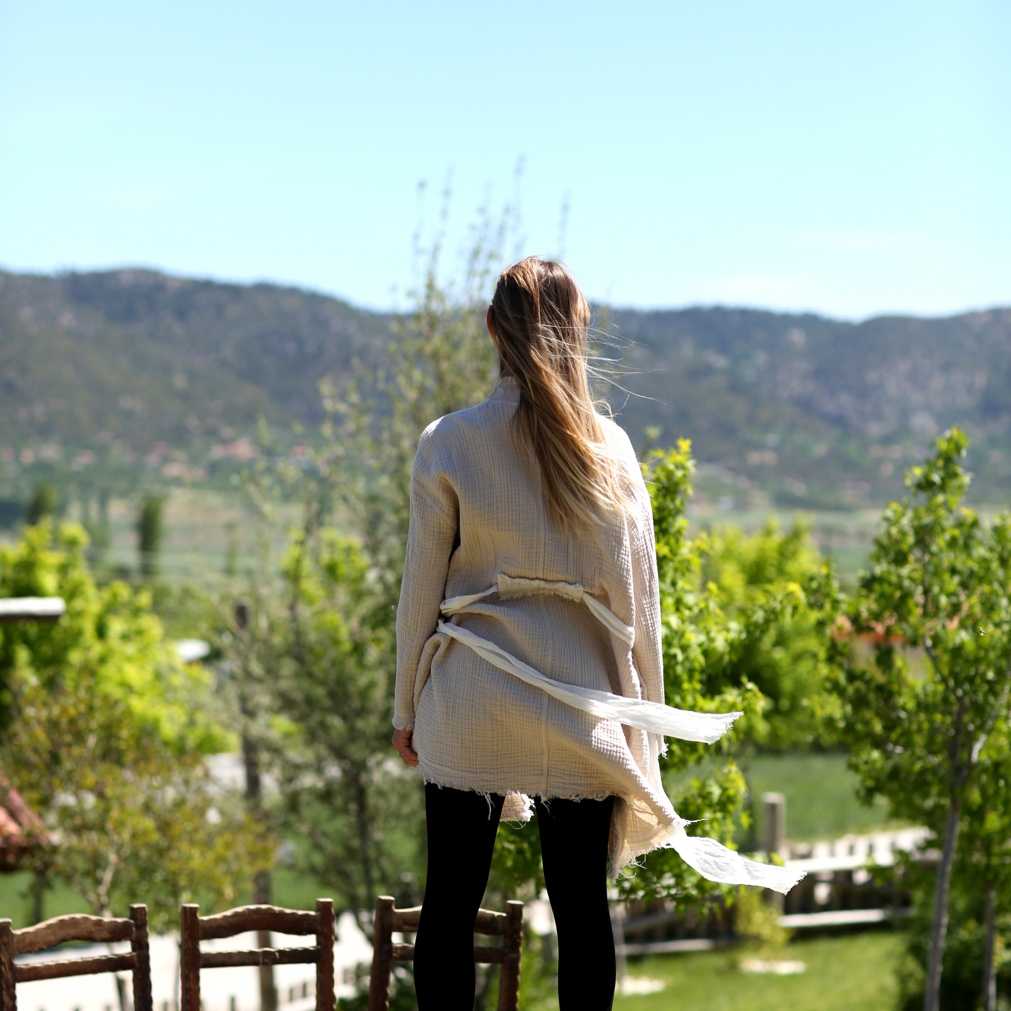 A girl wears natural color muslin jacket, open front, long sleeves,