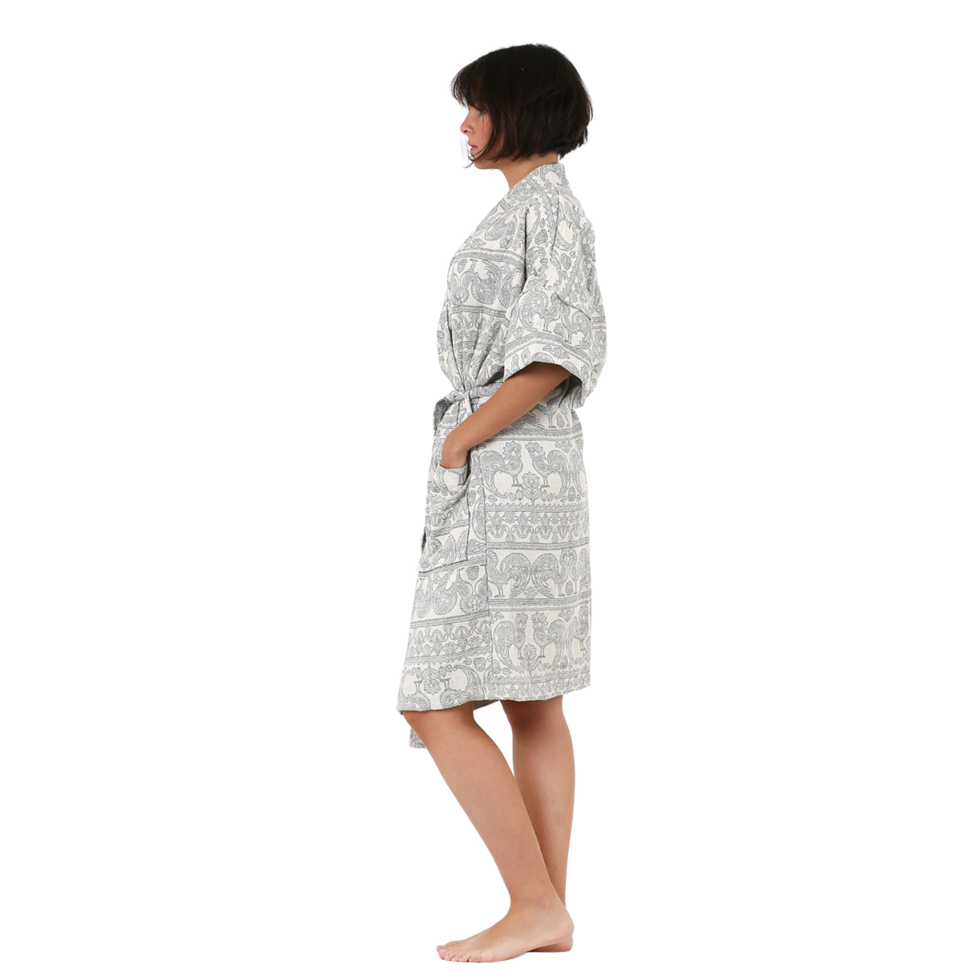 A girl standing sideways is wearing Trimita Muslin Kimono Bathrobe