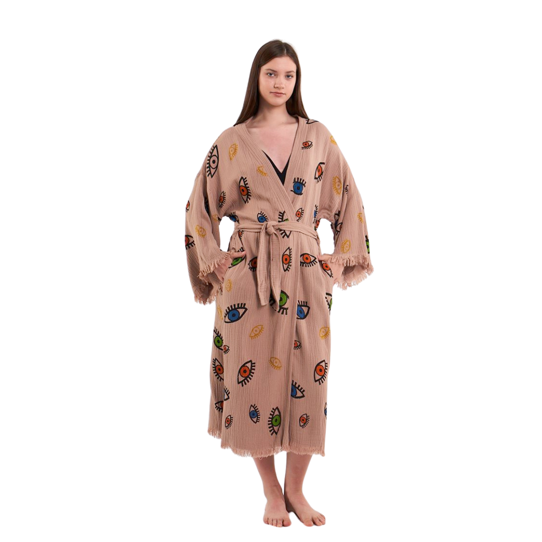 Full-body shot of a model wearing a beige kimono robe with a colorful eye pattern.