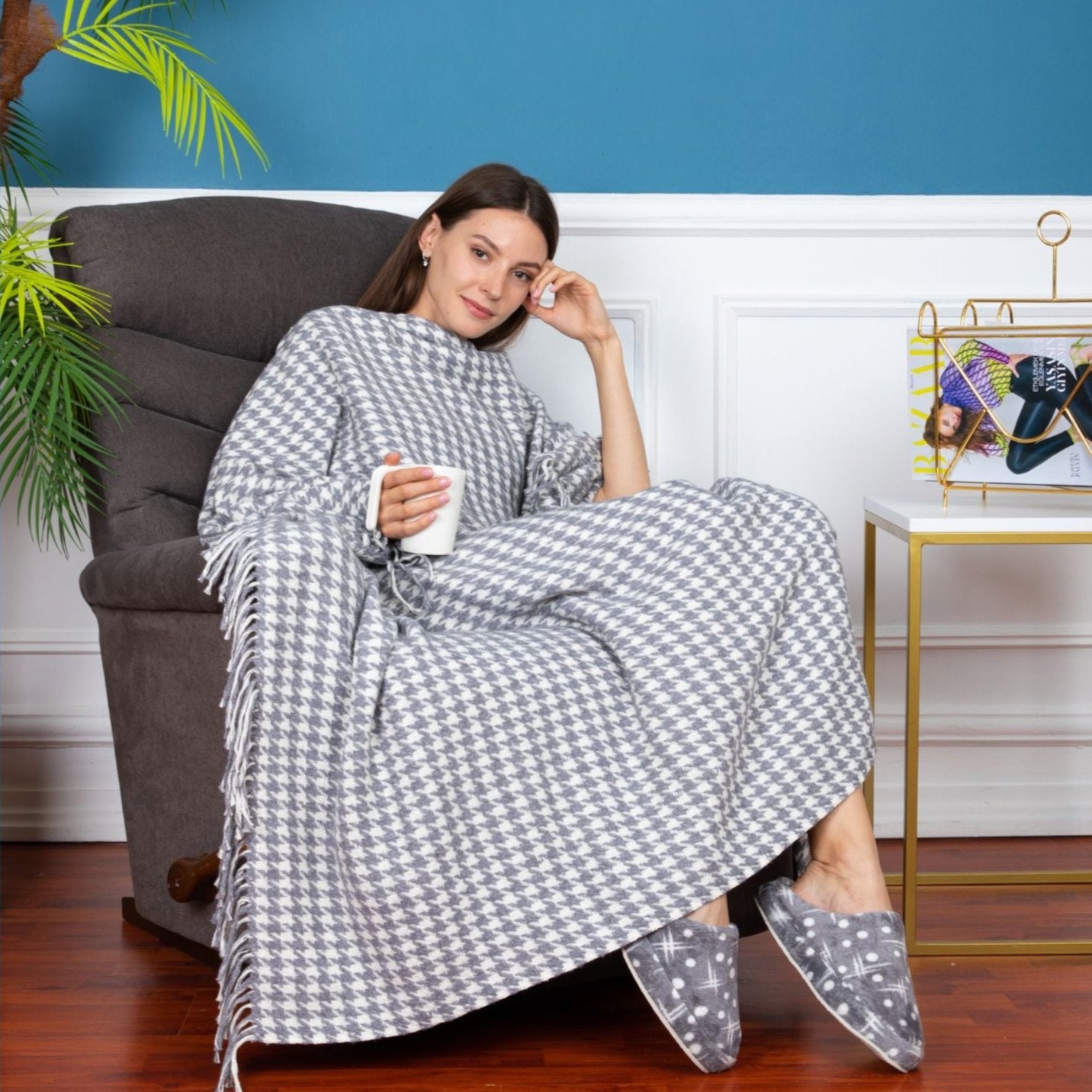 Trimita | Young girl comfortably sitting on a couch, wrapped in the Grey Houndstooth Luxury Throw Blanket, demonstrating its coziness and optimal size.