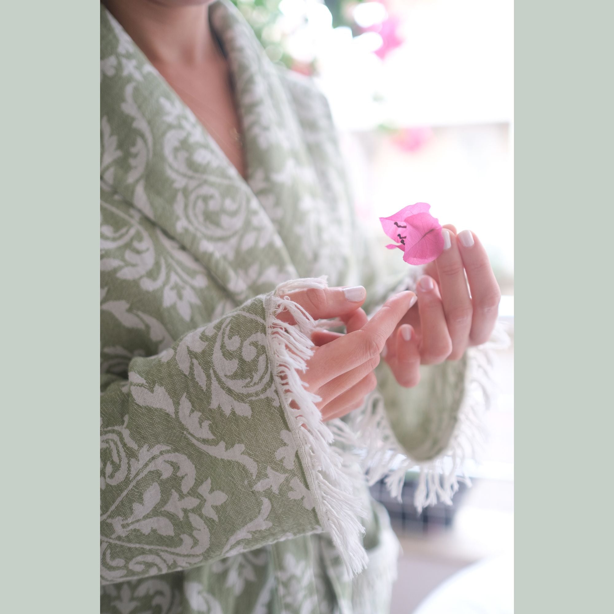 Green baroque patterned bathrobe with tassels.
