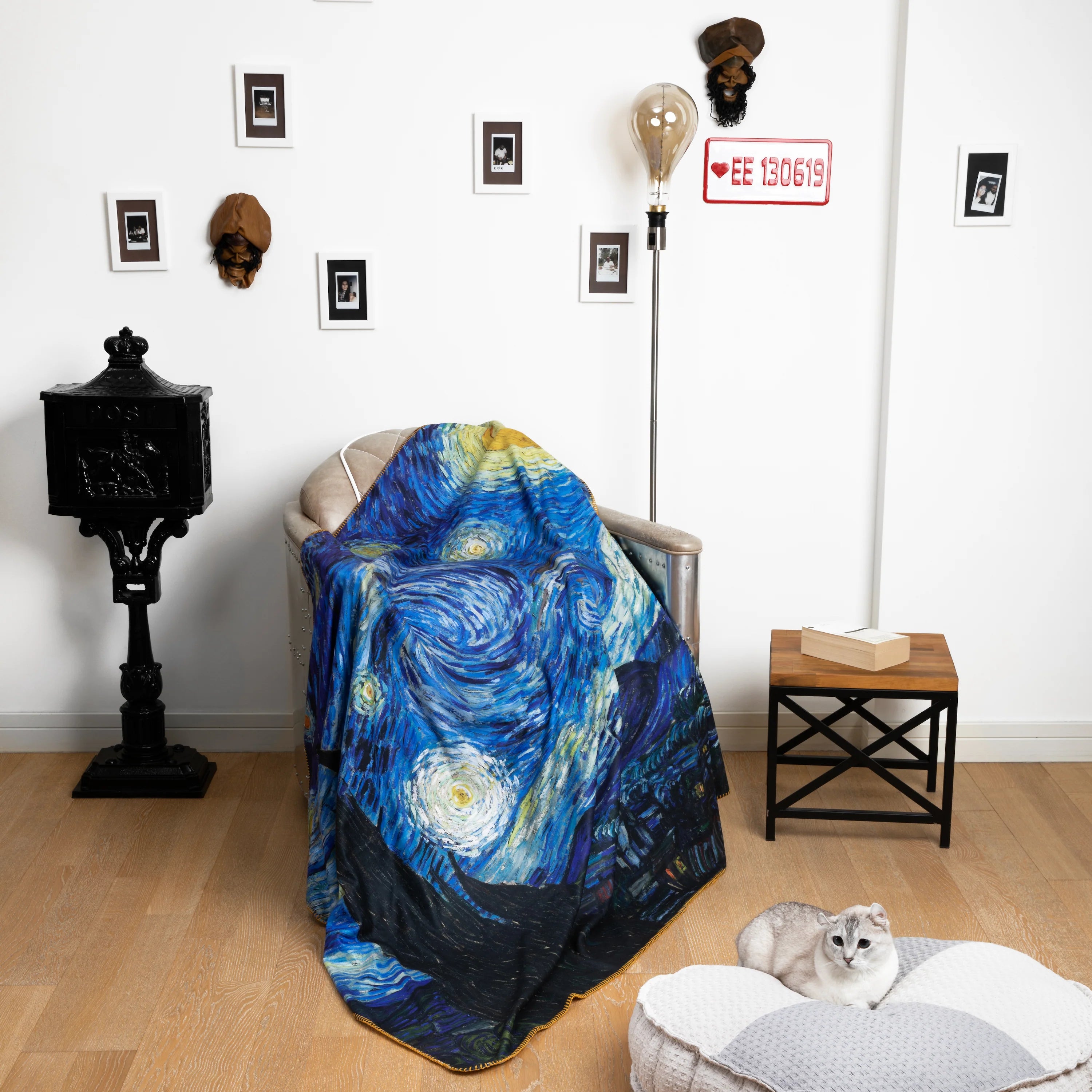 Van Gogh's iconic Starry Night blanket is draped over the armchair.