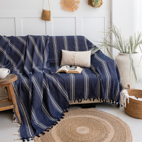 Navy striped blanket draped over a sofa in a cozy living room.