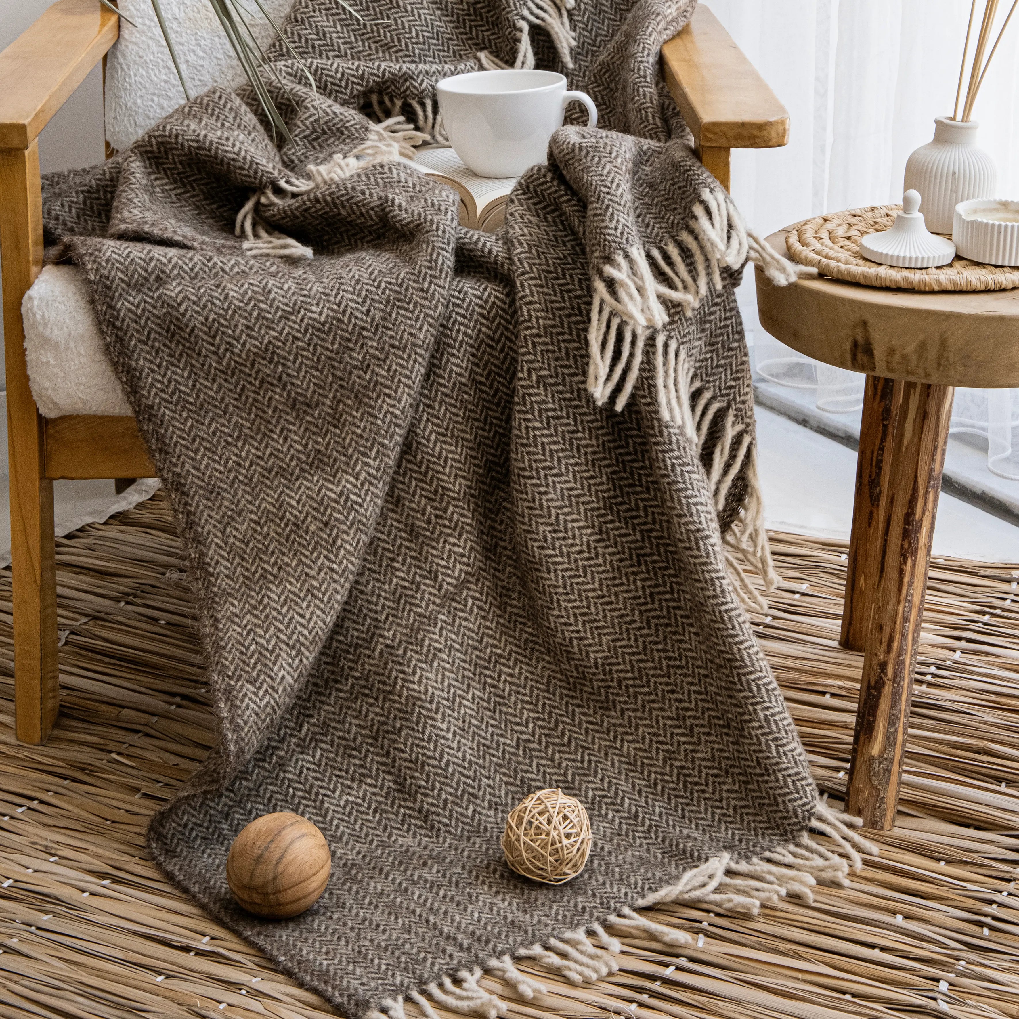 Trimita Ladira brown wool throw on wooden chair with book, handcrafted in Türkiye for cozy homes