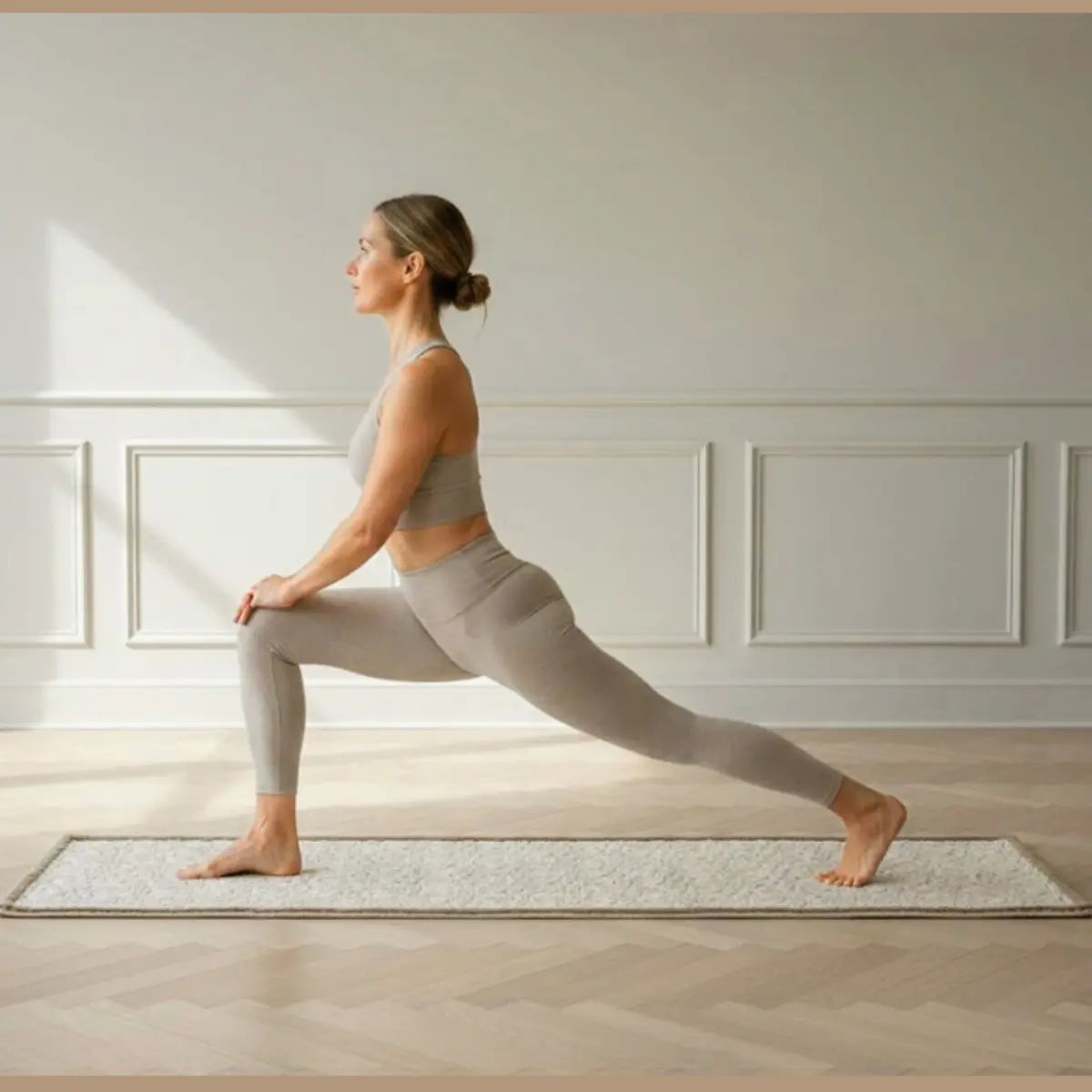 Woman practicing yoga in a serene room with sunlight streaming in