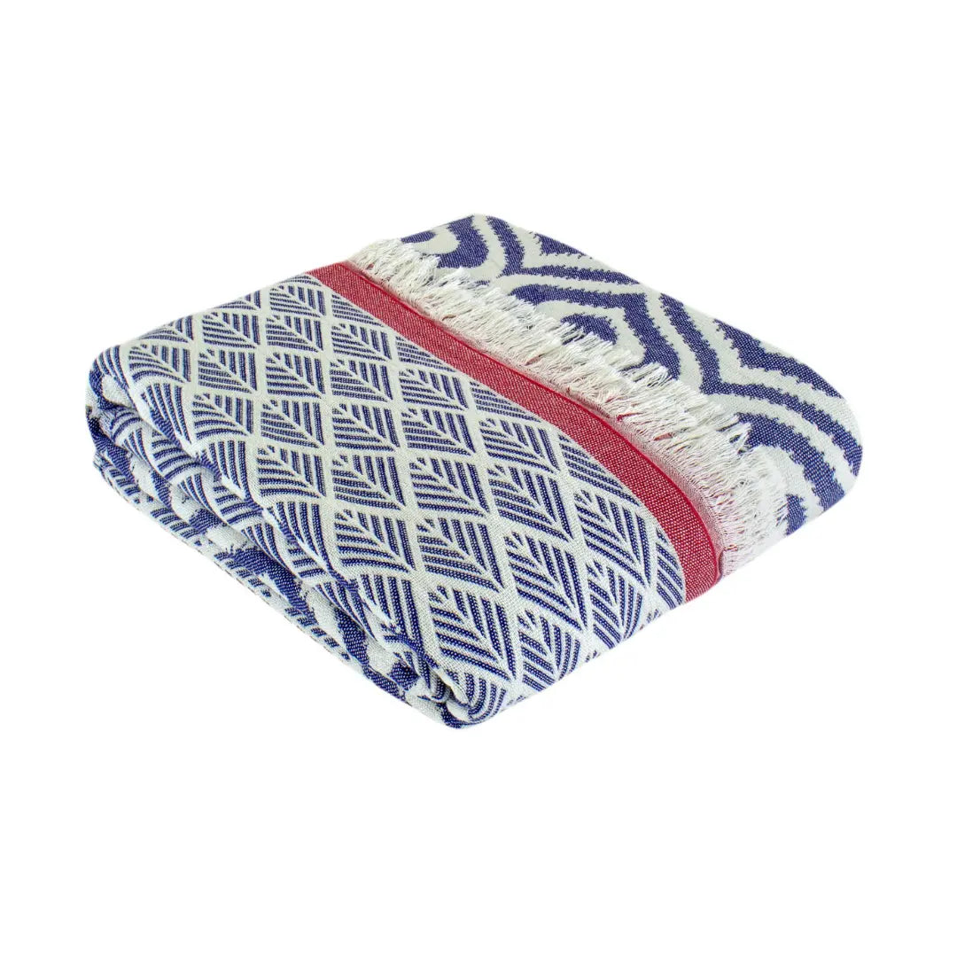 Close-up of a folded navy blue and red striped cotton throw with intricate geometric patterns, durable and soft 100% Turkish cotton for all-season use.