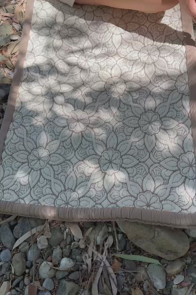 Close-up of the floral Lotus yoga mat, followed by a woman meditating outdoors.