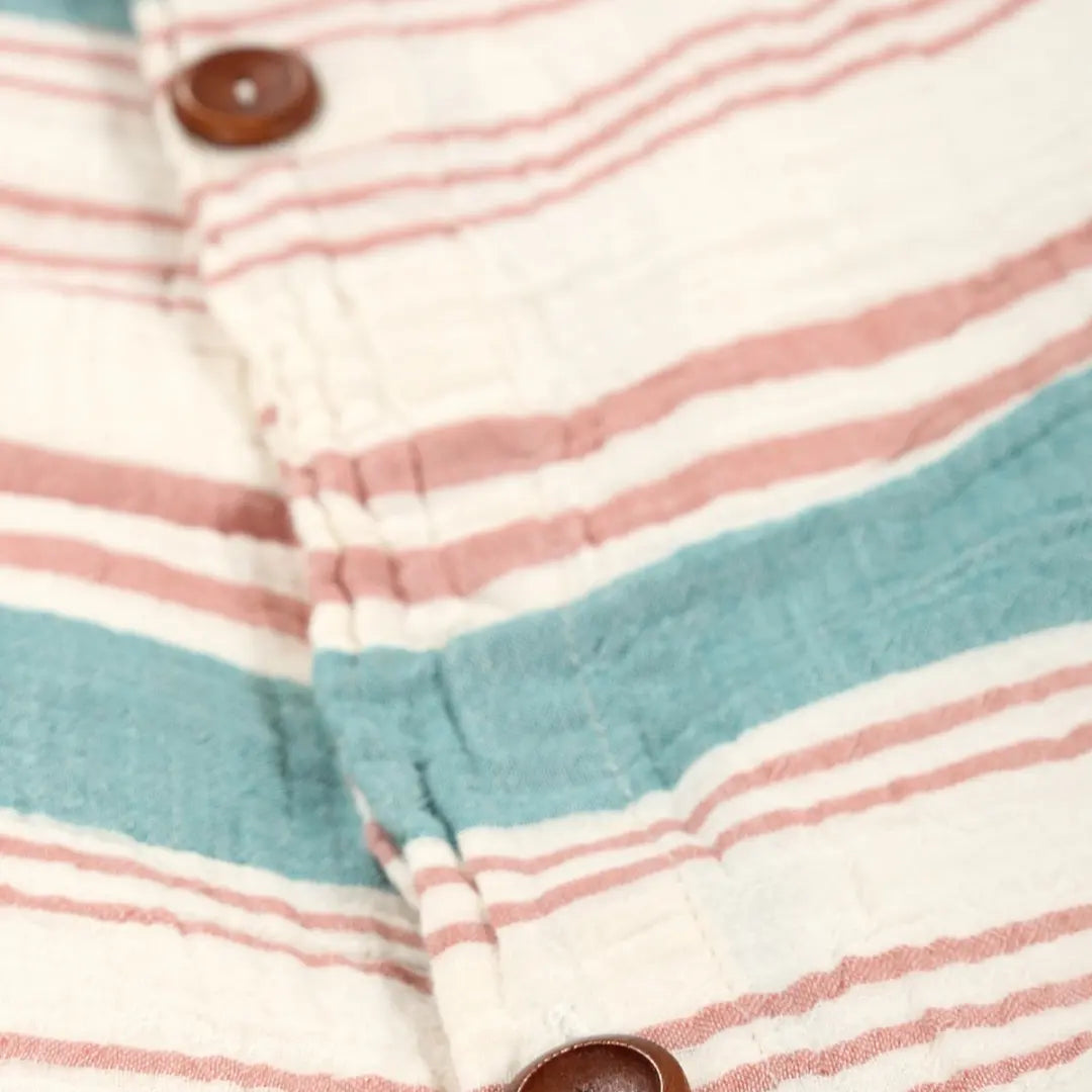 Close-up of a striped fabric with buttons on a multicolored background