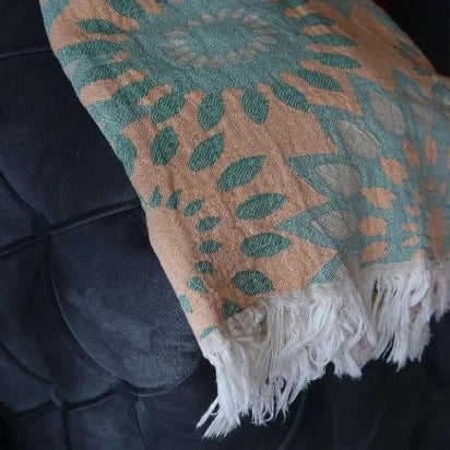 Detailed close-up of Trimita jacquard woven Turkish towel fabric and handmade white fringe tassels.