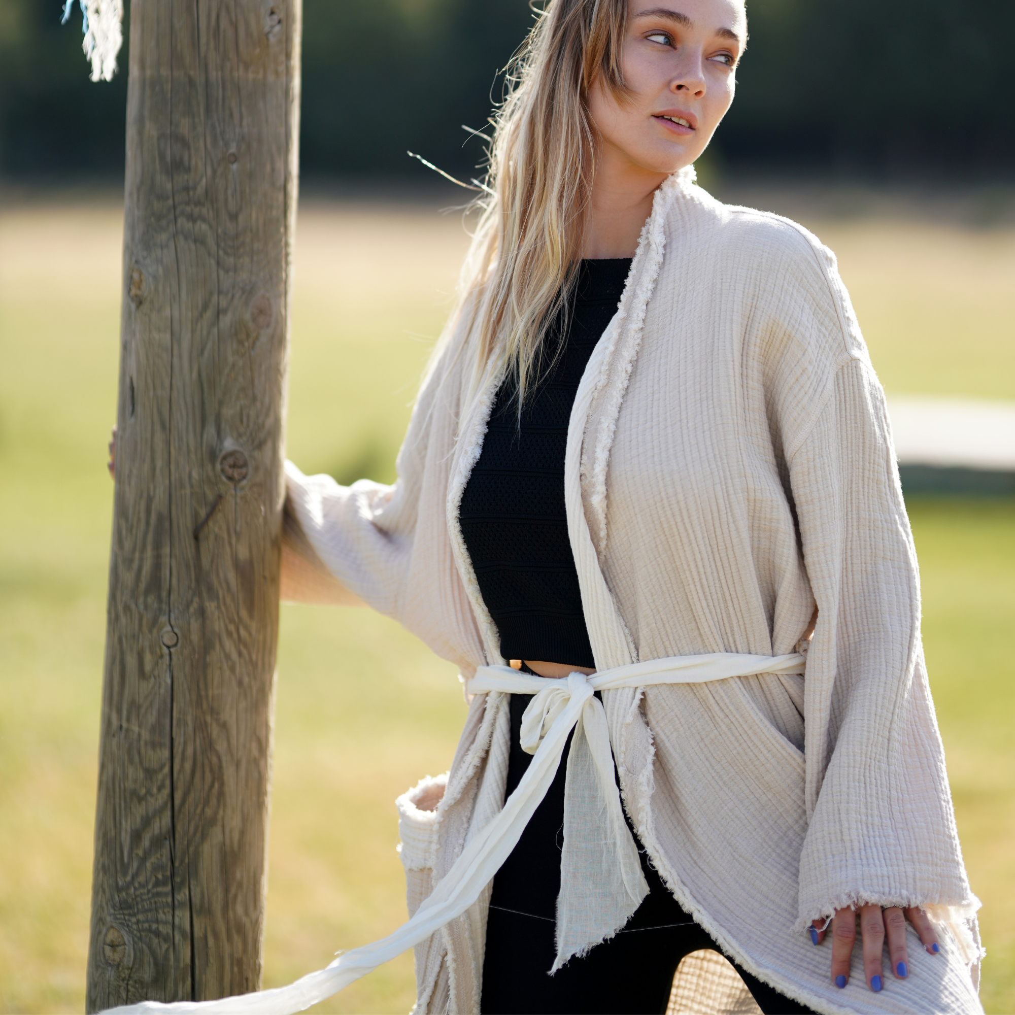A girl wears natural color muslin jacket, open front, long sleeves